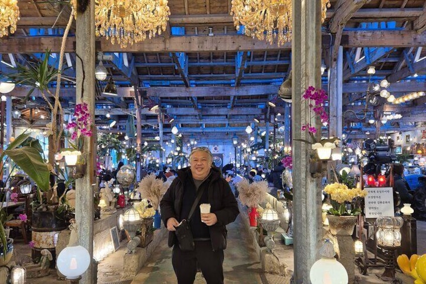 Un mercado con varios puestos y decoraciones colgantes. 4
