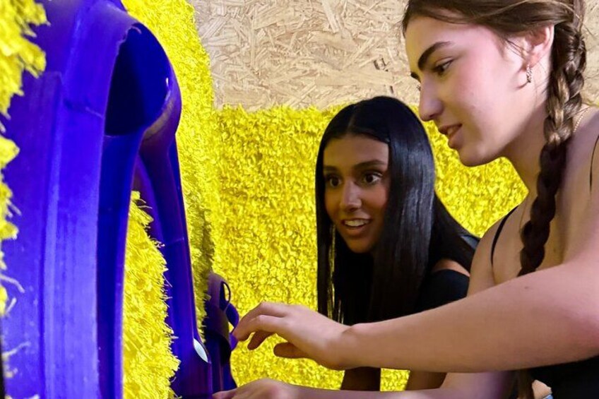 Two individuals engaged in an activity with a yellow textured background. 4