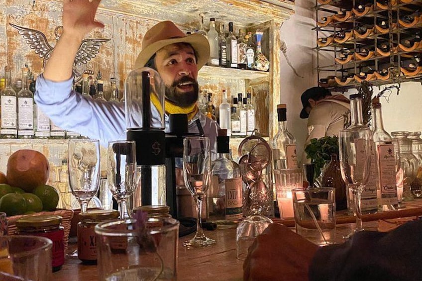 A bar with a bartender, bottles, glasses, and a decorative background. 2
