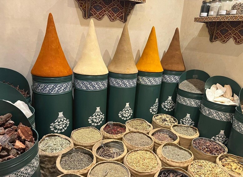 A variety of spices displayed in both conical containers and round bags. 4