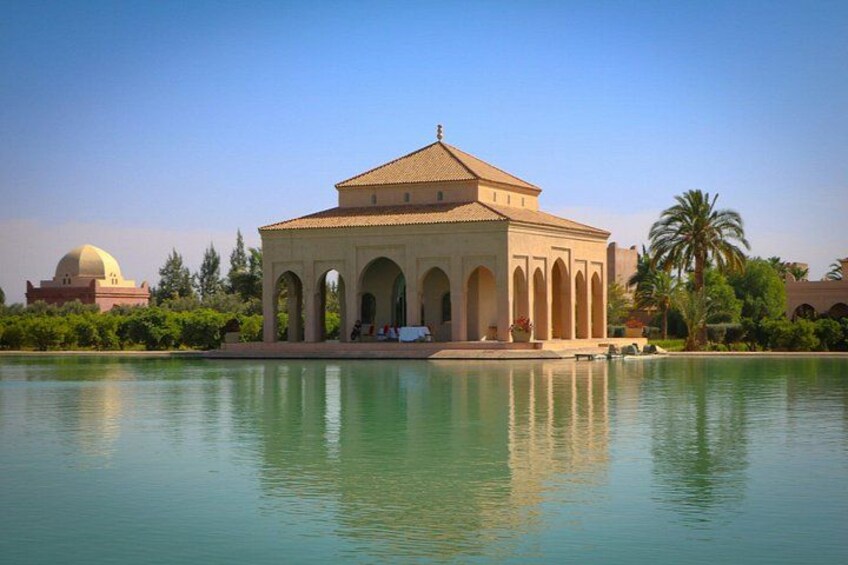 Un gran edificio con una cúpula y arcos, rodeado de agua y palmeras. 2