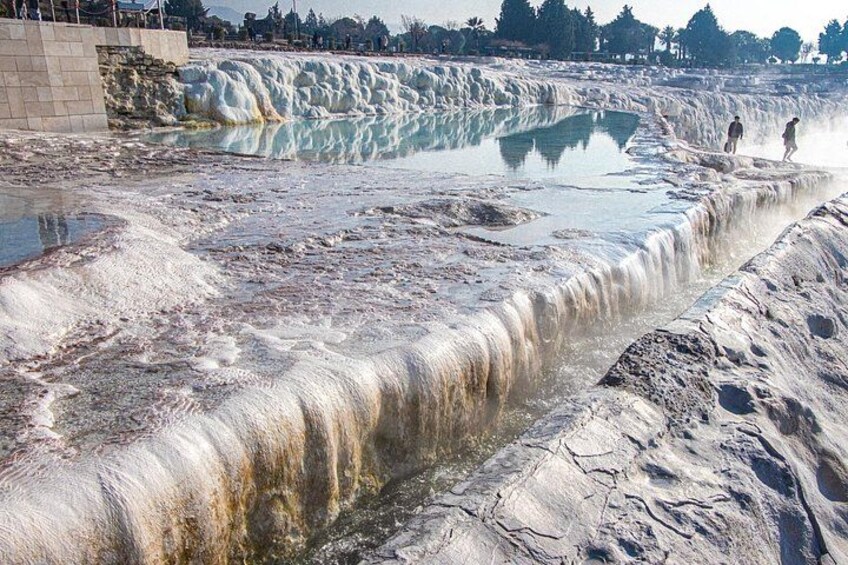 A natural hot spring with mineral deposits and a pool of water. 1