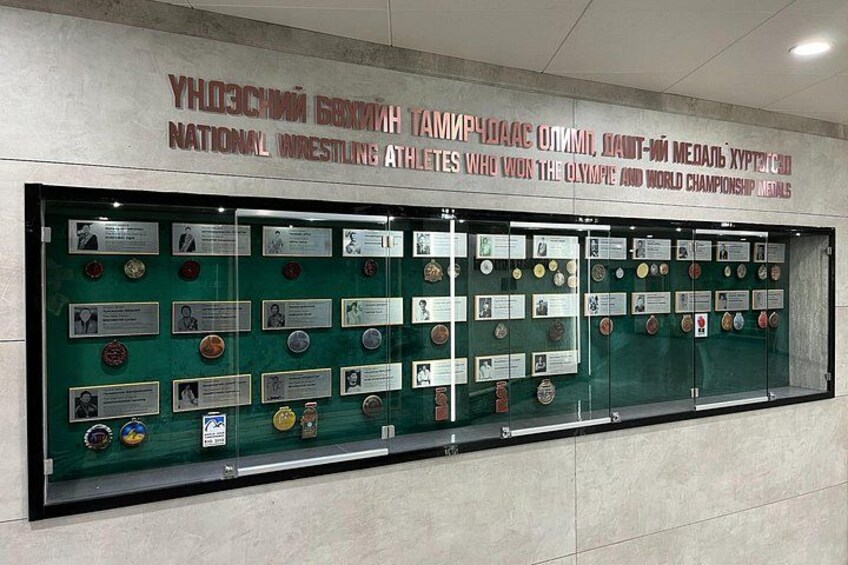 A display case with medals and plaques. 5