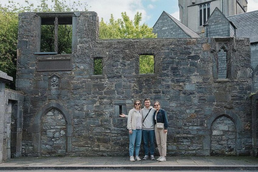 A stone building with arched windows and a weathered facade. 3