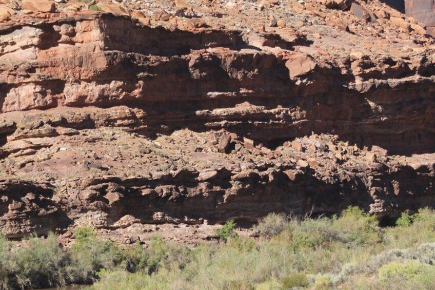 A rugged rock formation with layered sedimentary structures. 5