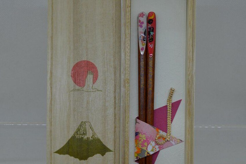 Un pannello di legno con un cerchio rosso e un motivo che raffigura una montagna verde. 4
