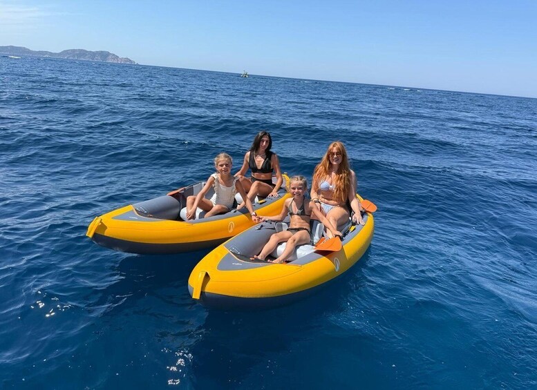 Three people on a yellow inflatable raft in the ocean. 5