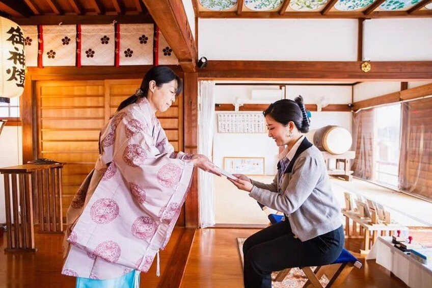 A traditional Japanese interior with tatami flooring, wooden beams, and shoji screens. 1