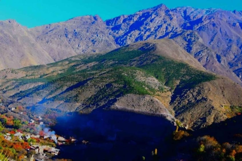 A mountainous landscape with a village at the base. 4