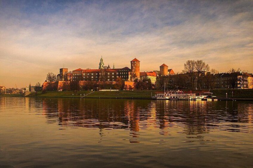 A historic cityscape with a castle, a river, and a boat. 3