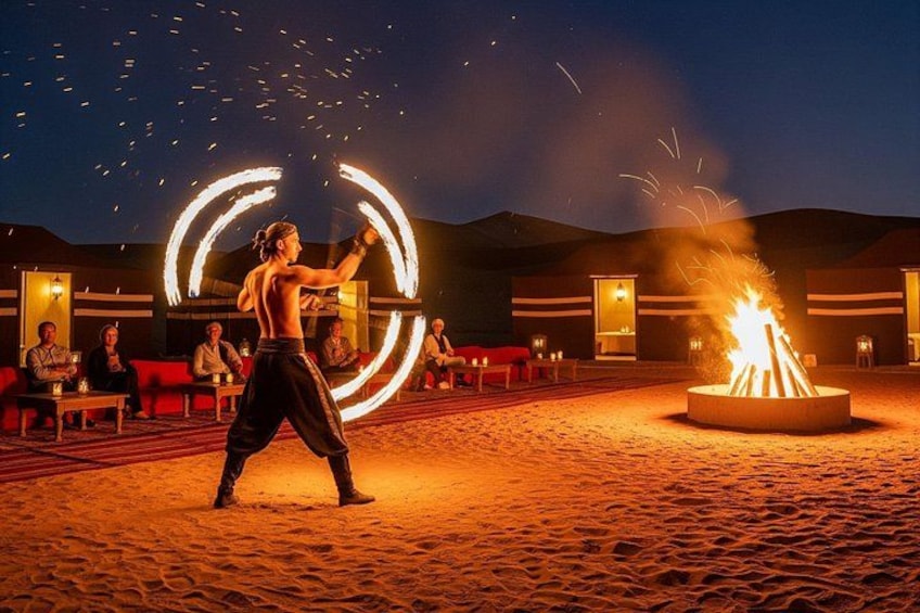 A person performing fire dancing with a circular light trail in a desert setting. 5