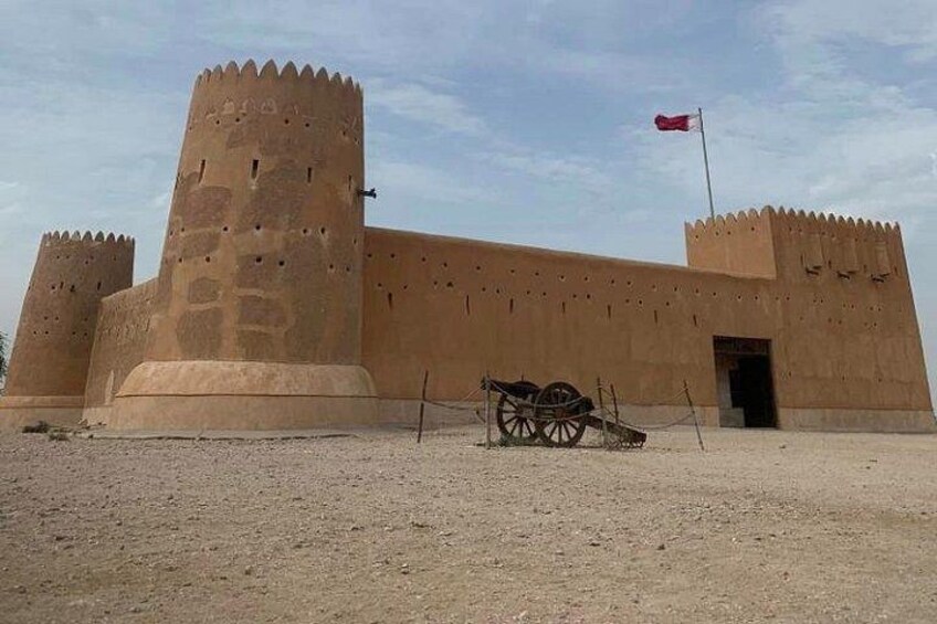 A large fortress with two prominent towers and a flagpole. 1