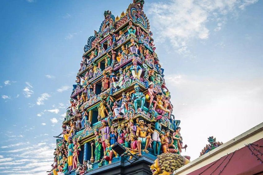 A multi-tiered temple with intricate carvings and statues. 5