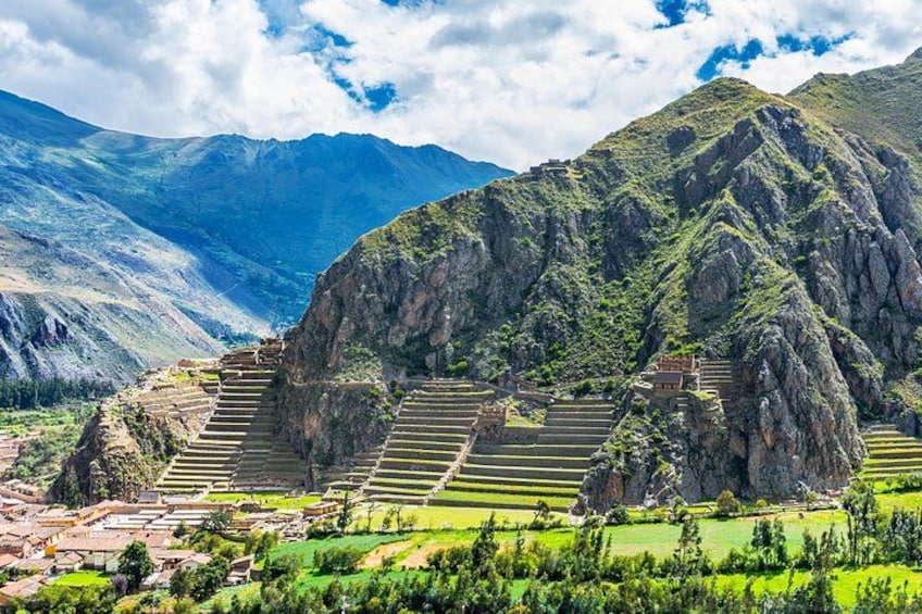Terraced agricultural fields, a mountain, and a small building. 1