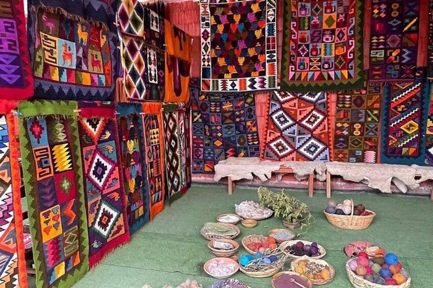 A display of colorful woven textiles with a variety of patterns and designs. 3