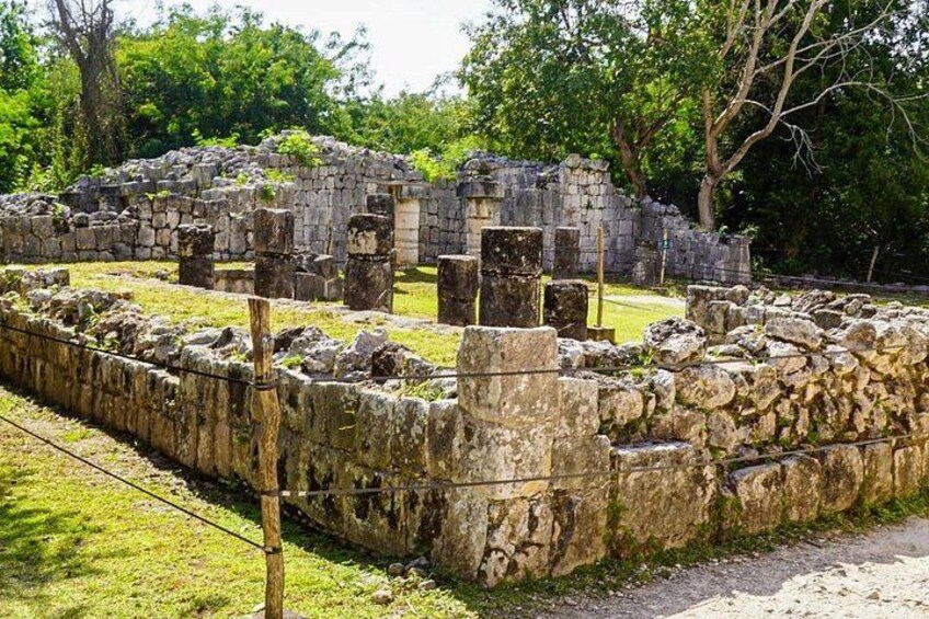 Ancient stone ruins with columns and walls, surrounded by greenery. 3