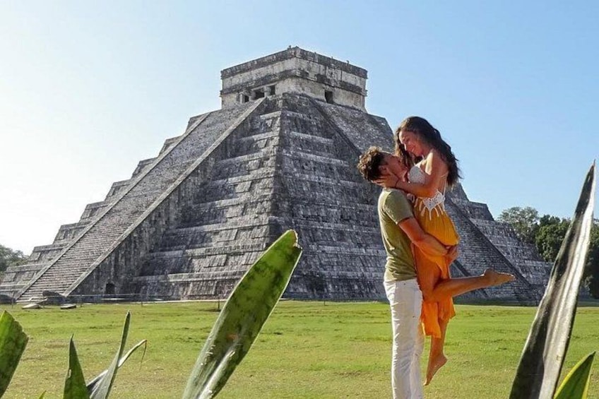 A pyramid, a person carrying another, and green grass. 2