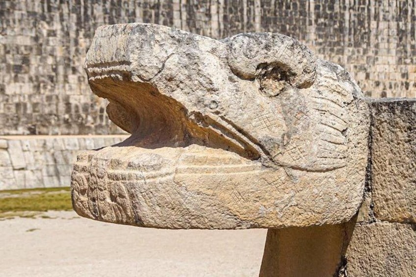 A stone sculpture of a head with a prominent jawline and teeth. 4