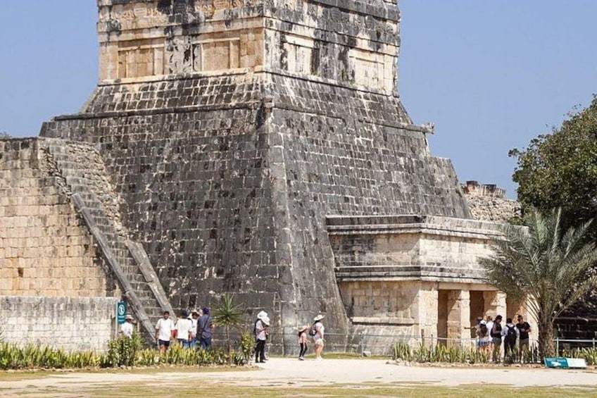 A large ancient pyramid with a staircase leading up to the entrance. 5