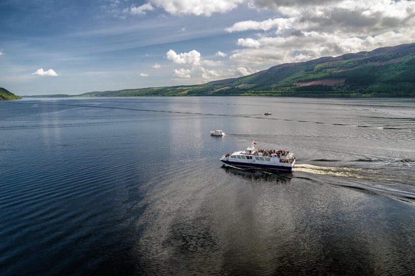 A boat on a calm lake with hills in the background. 5