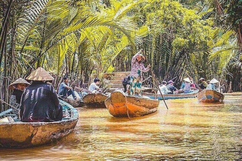 People in traditional boats on a river surrounded by dense tropical vegetation. 4