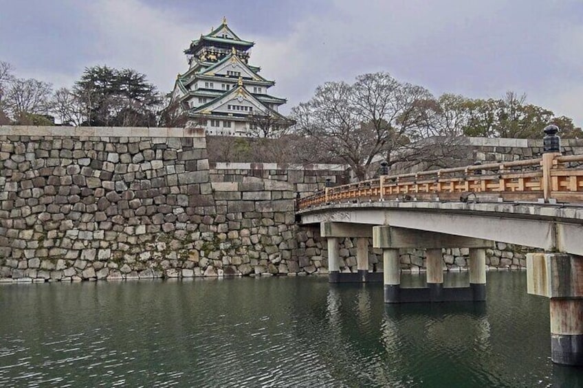 A stone wall, a bridge, and a castle in the background. 2