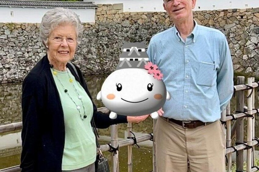 Two people holding a plush toy. 2