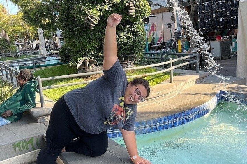 A person sitting by a pool with water splashing around them. 4