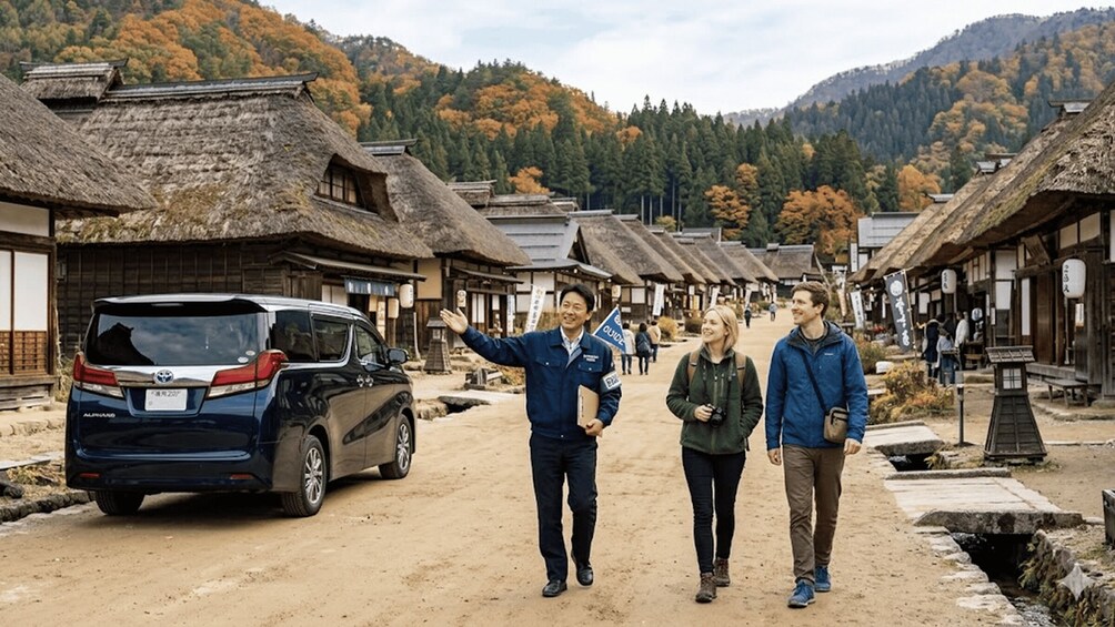 A traditional village street with thatched-roof buildings, a parked car, and a mountainous backdrop. 2