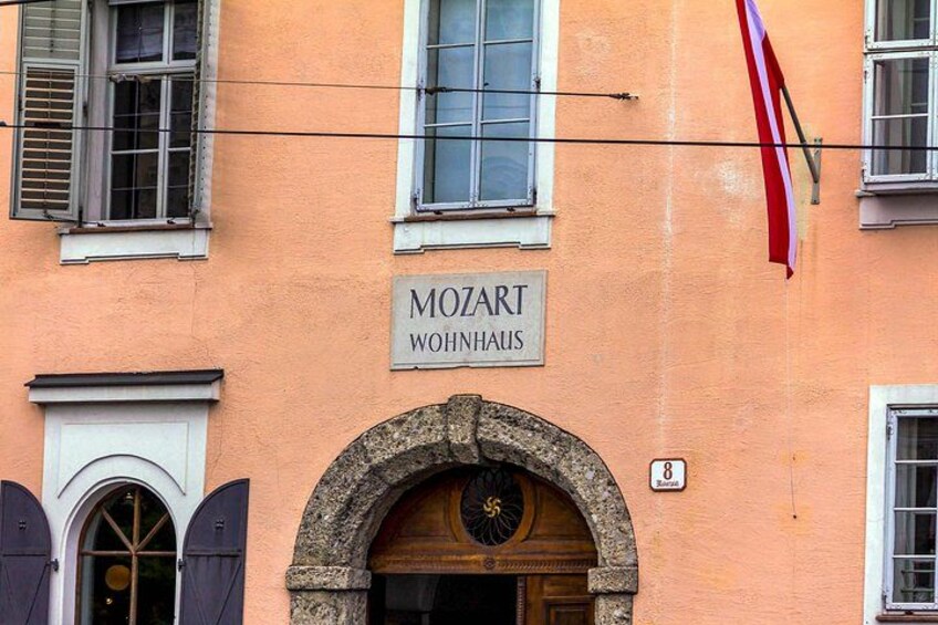 A building with a sign reading 'MOZART WOHNAUS' and a flag. 2