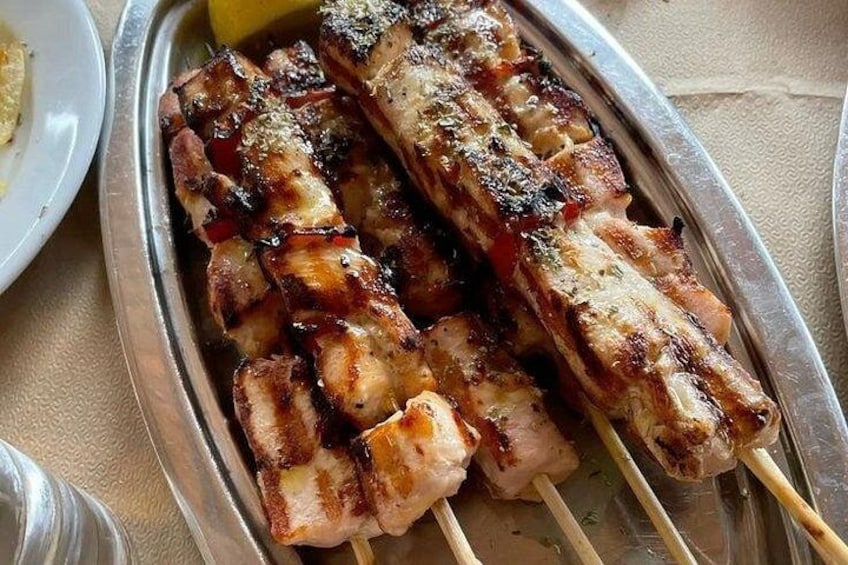 Grilled chicken skewers on a metal tray. 2