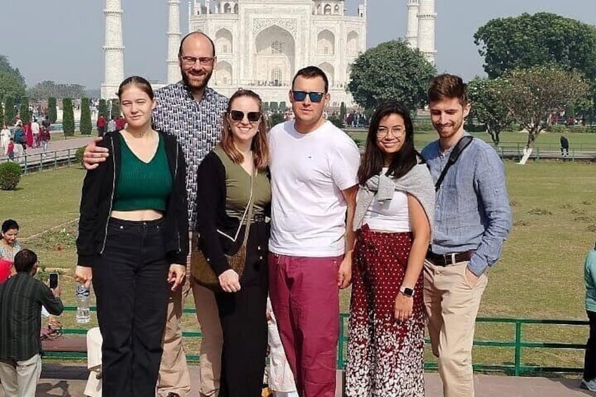 Een groep mensen staat voor de Taj Mahal. 1