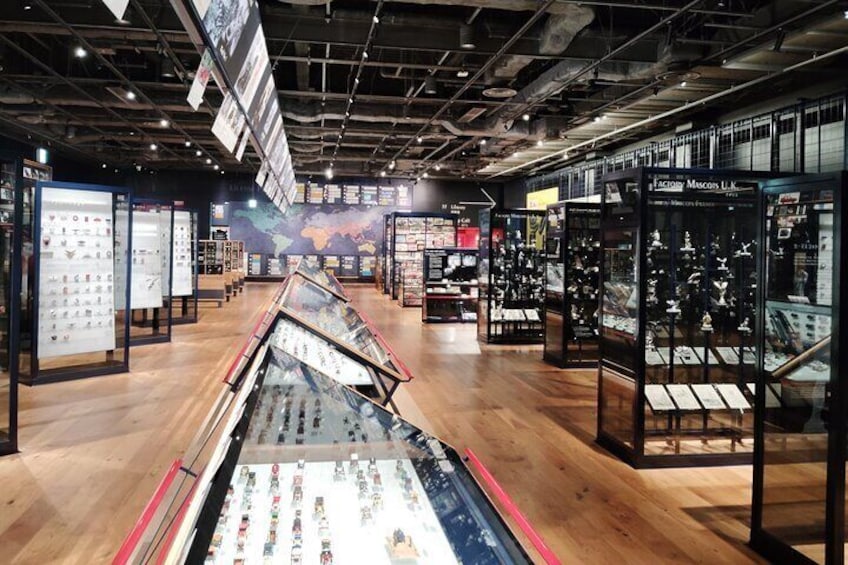 A museum with glass display cases and a wooden floor. 3