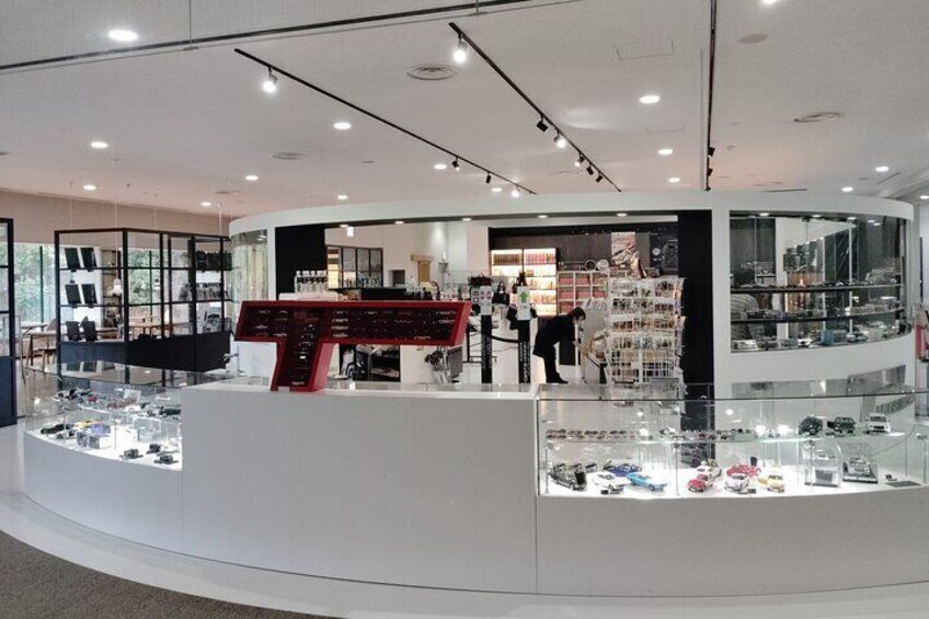 A modern jewelry store with glass display cases and a central checkout counter. 2