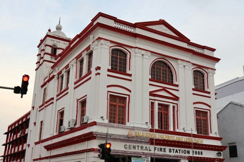 A white building with red trim and arched windows, labeled as the Central Fire Station 1908. 4