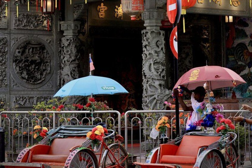 A traditional carriage with red and white decorations, a blue umbrella, and a person holding a red umbrella. 3