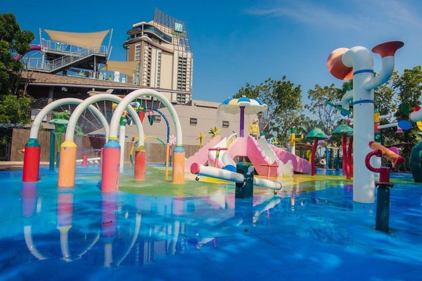 A water park with colorful play structures and a large pool. 2