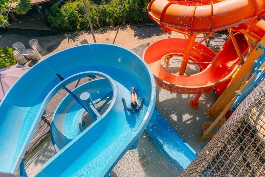 A water park with a blue water slide and an orange water slide. 5