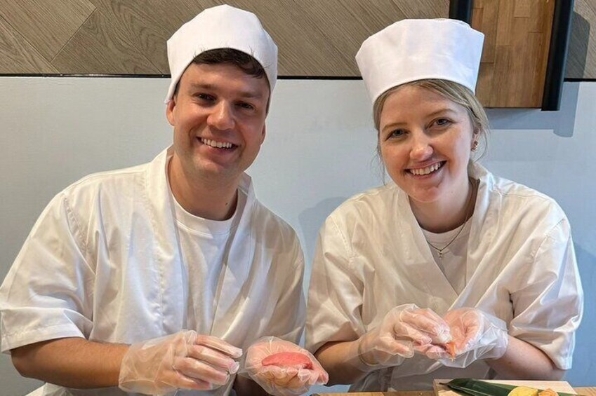 Two people in chef uniforms holding food items. 5