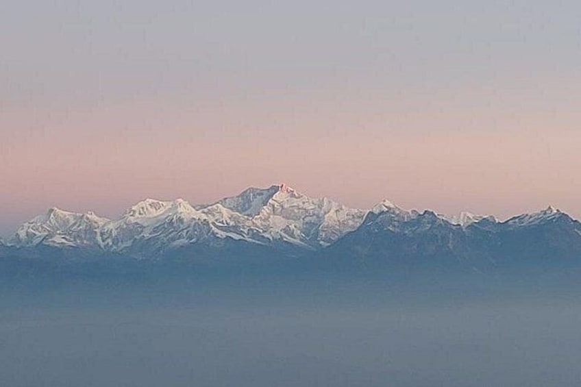 A range of snow-capped mountains under a clear sky. 4