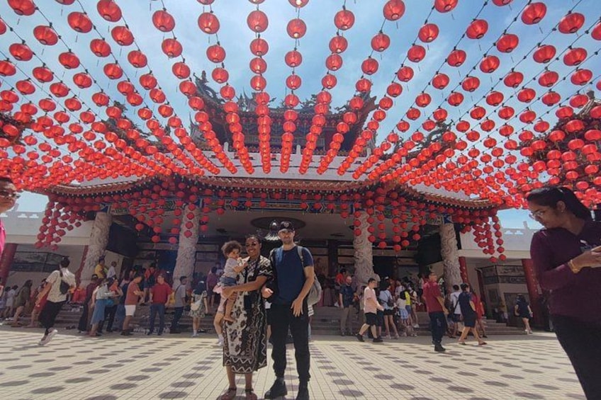 A traditional building with a tiled floor and red lanterns hanging above. 2