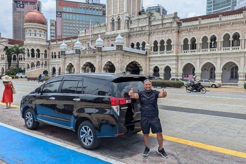 A black SUV parked on a street with a historic building in the background. 5