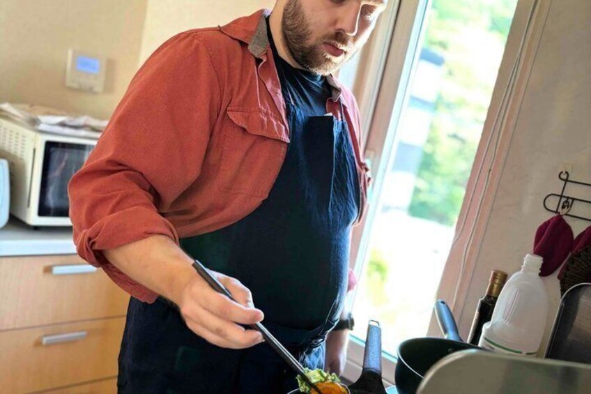A person cooking in a kitchen. 3