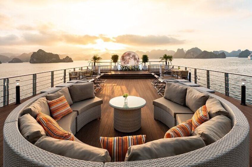 Une terrasse dotée d’un canapé circulaire, d’une table basse ronde et offrant une vue sur la mer et les îles. 5