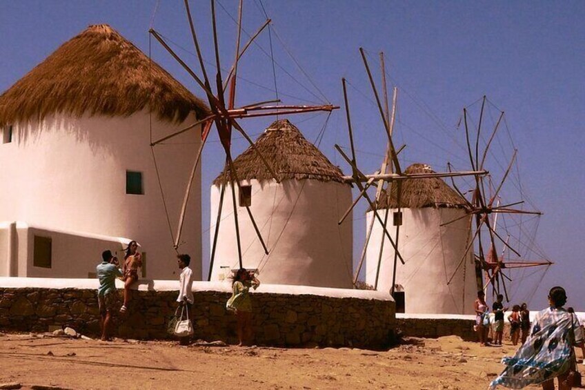 Weiße Häuser im traditionellen Stil mit Strohdächern und Windmühlen. 1