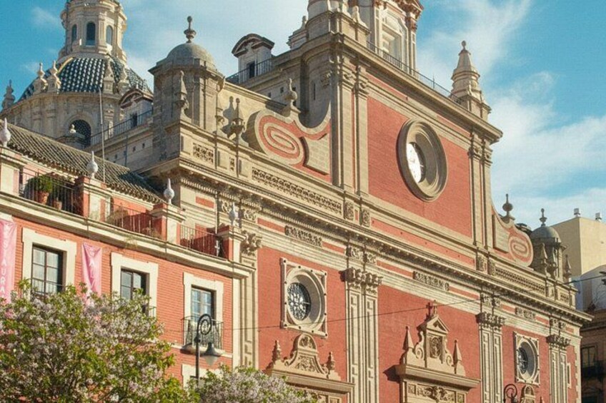 A historic building with ornate architecture, including domes and a clock tower. 2