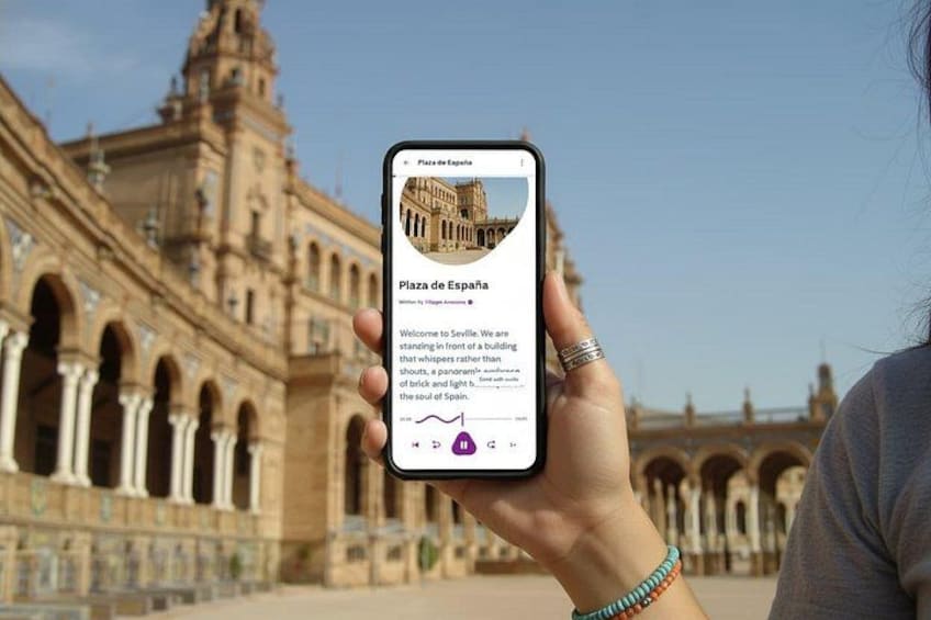 A person holding a smartphone displaying information about Plaza de EspaƱa. 1
