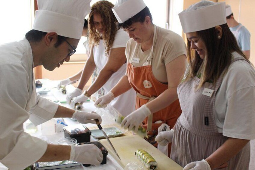 Chefs in white uniforms and aprons preparing food. 3