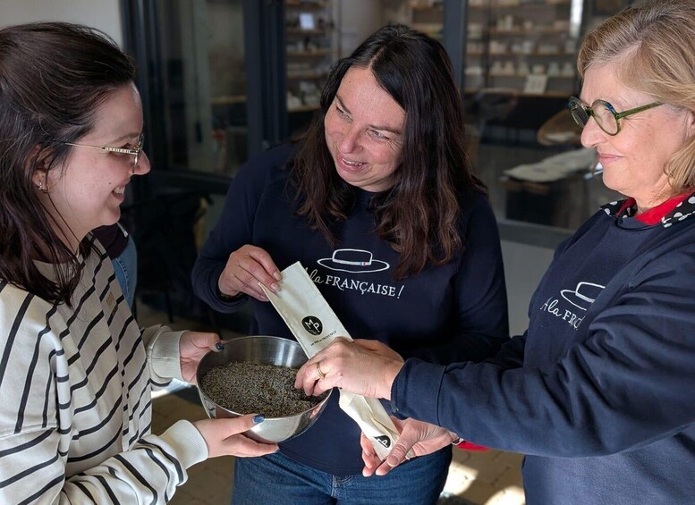Three people interacting with a bowl of seeds. 3