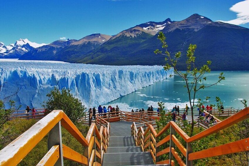 A glacier with a viewing platform and people observing. 1